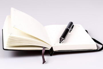 pen and diary or planner on white