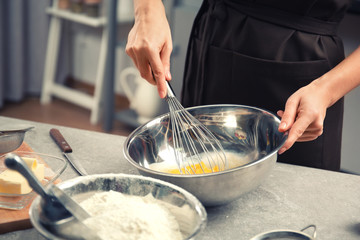 Fototapeta premium Young woman cooking in kitchen, closeup