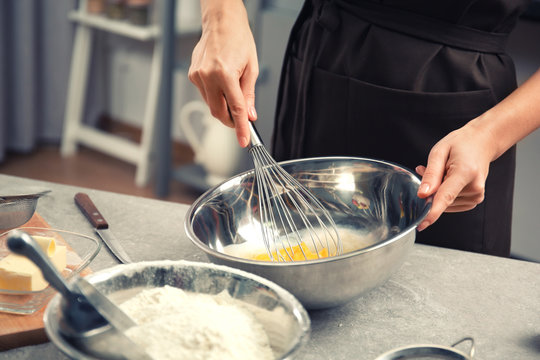 Young woman cooking in kitchen, closeup