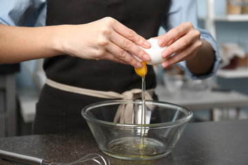 Obraz na płótnie Canvas Young woman cooking in kitchen, closeup