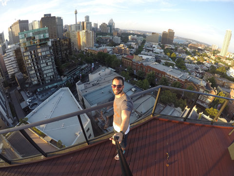Man taking a selfie with Sydney Skyline on background, Australia