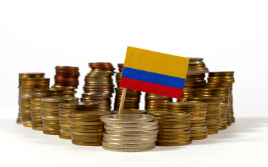 Colombia flag waving with stack of money coins