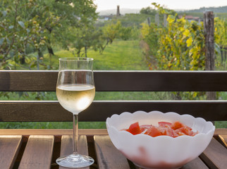 Glass of wine on wooden table with picturesque view