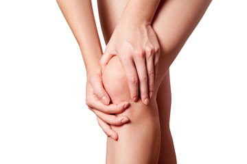 Closeup view of a young woman with knee pain. isolated on white background.
