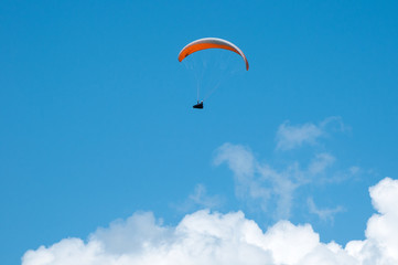Paraglider flying in the sky on a paraglider. Paragliding.