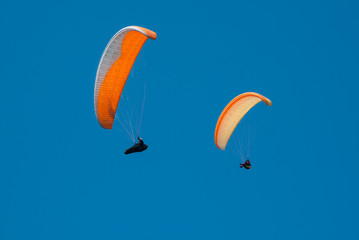 Paraglider flying in the sky on a paraglider. Paragliding.