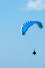 Paraglider flying in the sky on a paraglider. Paragliding.