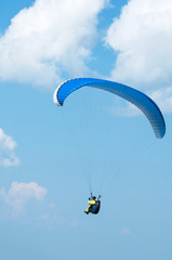 Paraglider flying in the sky on a paraglider. Paragliding.