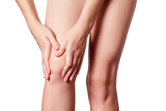 Closeup view of a young woman with knee pain. isolated on white background.
