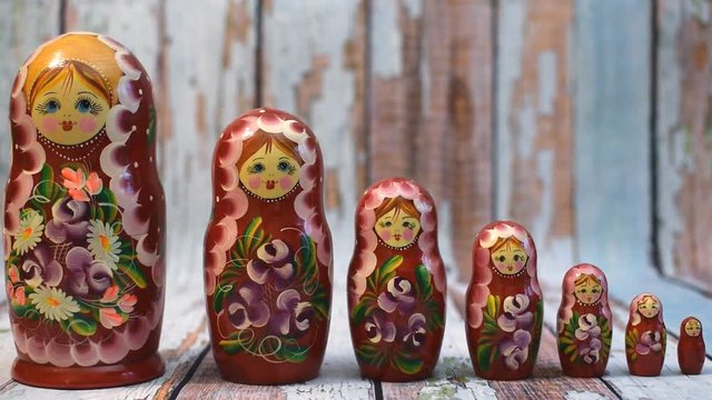 Matrioshka or babushkas dolls on a wooden background