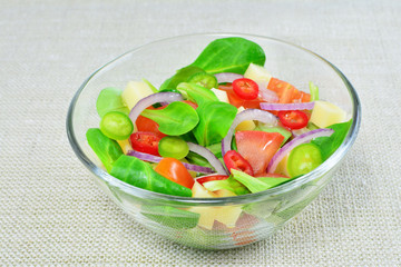 Fresh vegetable salad in glass bowl on the table
