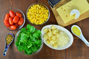 Fresh vegetable salad ingredients, sweet corn, lamb's lettuce, cheese, chilly, sweet pepper and tomatoes