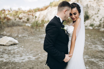 Stylish wedding couple posing outdoor