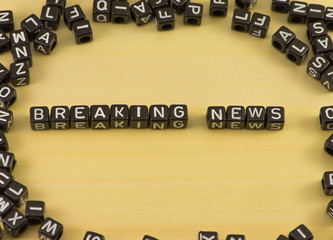 The word Breaking news on wood background