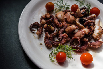fried in olive oil, octopus tentacles with cherry tomatoes and spices