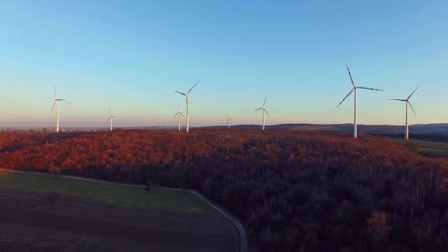 Wind turbines on field, filmed at susnet with a drone