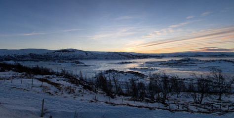 Panoramic view of winter landscape with rocks and frozen lake