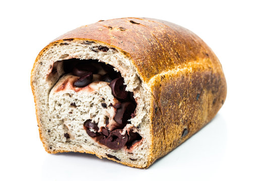 Traditional Mediterranean Strudel bread with inside black olives on white background