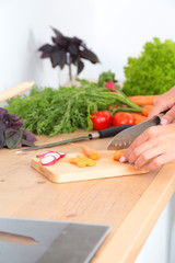 Fresh vegetables on the cutting board are falling in the pot, concept of cooking