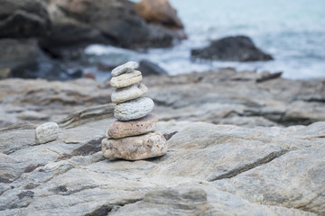 Fototapeta na wymiar Stacked stone, rock stacking near sea shore, Thailand traveling
