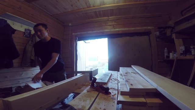 Man work with wood plank. Woodworking footage