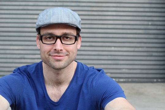 Handsome male with glasses and hat portrait