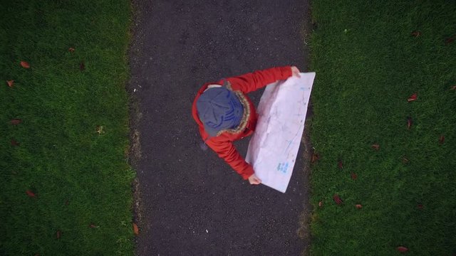 4k Aerial above Houses and Child Looking in Map, zoom out normal speed
