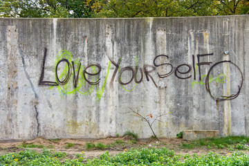 inspirational graffiti on grungy cement city wall