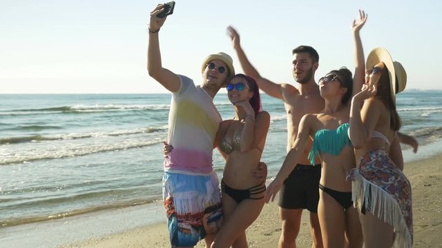 Group of friends taking selfie on the beach