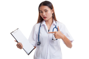 Asian young female doctor upset  point to blank clipboard.