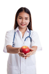 Young Asian female doctor show an apple.