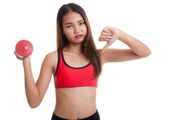Beautiful Asian healthy girl thumbs down with dumbbell.