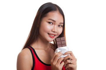 Beautiful healthy Asian girl eat chocolate.