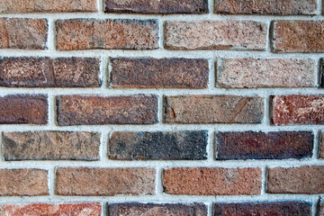 Multi-hued brick wall with gray mortar