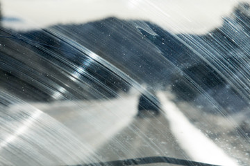 Windshield smeared in an arc by a windshield wiper