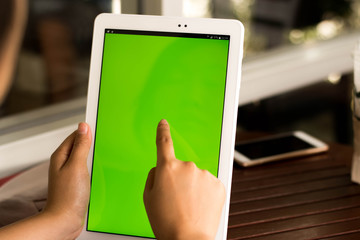 Women touch tablet green screen concept technology. 