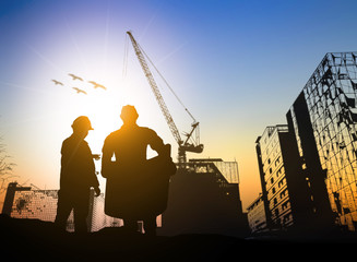 Silhouette engineer standing orders for construction crews 