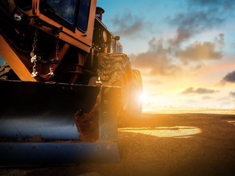 Silhouette Wheel loader Excavator with backhoe unloading sand at