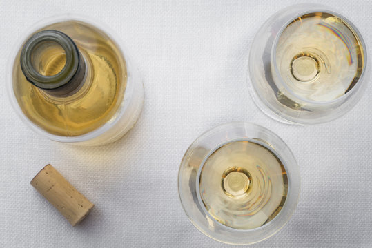 White Wine with Bottle and Cork on White Linen