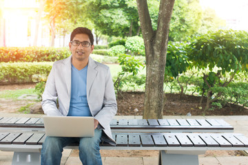indian busines male using laptop
