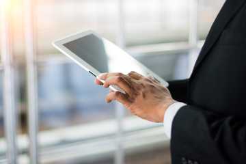 Business concept with man hand touching tablet computer