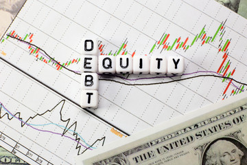Debt and equity letter cube on white candle stick chart background. conceptual image for D/E ratio in stock investment.