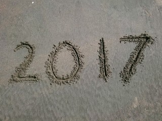 New year number on the beach . number is make from hand writing