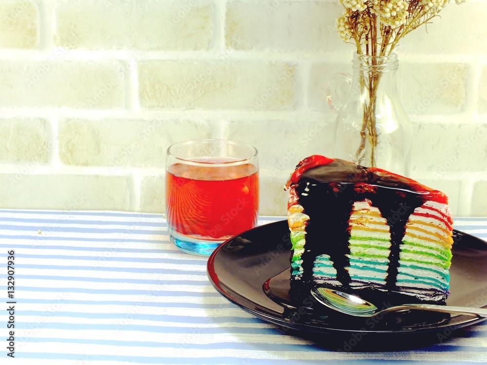 Wall mural rainbow cake slice with chocolate sauce