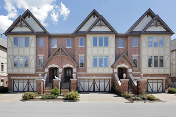 Row of tudor style brick townhouses