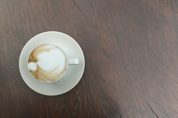 Close up white cup of Coffee, latte on the wooden table