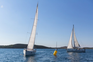 Obraz na płótnie Canvas Yachts at Sailing regatta at the Sea. Luxury boats.