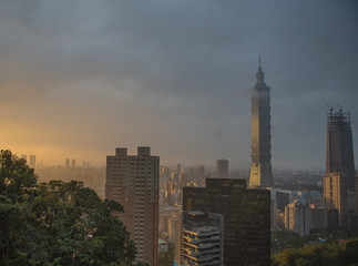 Taipei City skyline with urban skyscrapers at sunset.