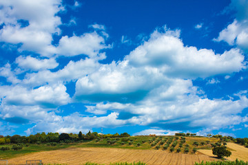 Italy landscape view with clouds on blue sky, Italian fields.