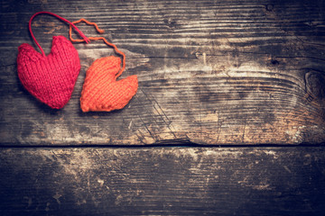 Valentine's Day. Colorful knitted hearts. Red heart on the dark old boards. Valentines day. Heart...